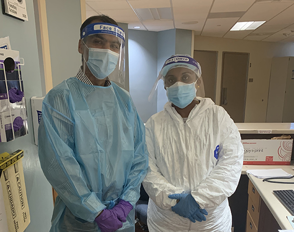 Photo of Doctor Lokesh Shahani and nurse Roshan Cherian wearing PPE to work in a special COVID-19 unit at UTHealth Harris County Psychiatric Center. Photo by UTHealth.